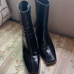 Black leather boots. 9 inches from top of boot to floor. 3-inch heel. Side zip.